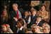 President George W. Bush and Mrs. Laura Bush sit with children of deployed U.S. military personnel and watch a performance of "Willy Wonka" by members of The Kennedy Center Education Department in the East Room Monday, Dec. 4, 2006. White House photo by Eric Draper 